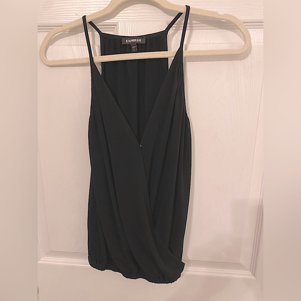 Black, sleeveless spaghetti strap top. Crosses, appears layered in the front.